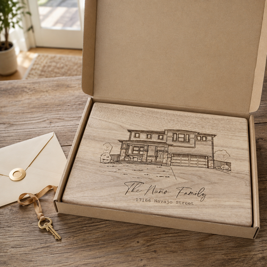 Custom engraved house portrait cutting board leaning against a kitchen backsplash