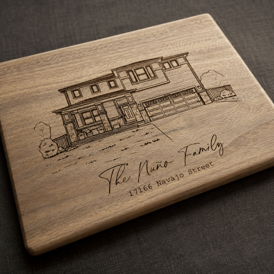 Custom engraved house portrait cutting board lying flat on a table
